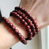 Red Tibetan Mala Beads 108 Pieces Worn on Wrist by Garden of Alice Customer
